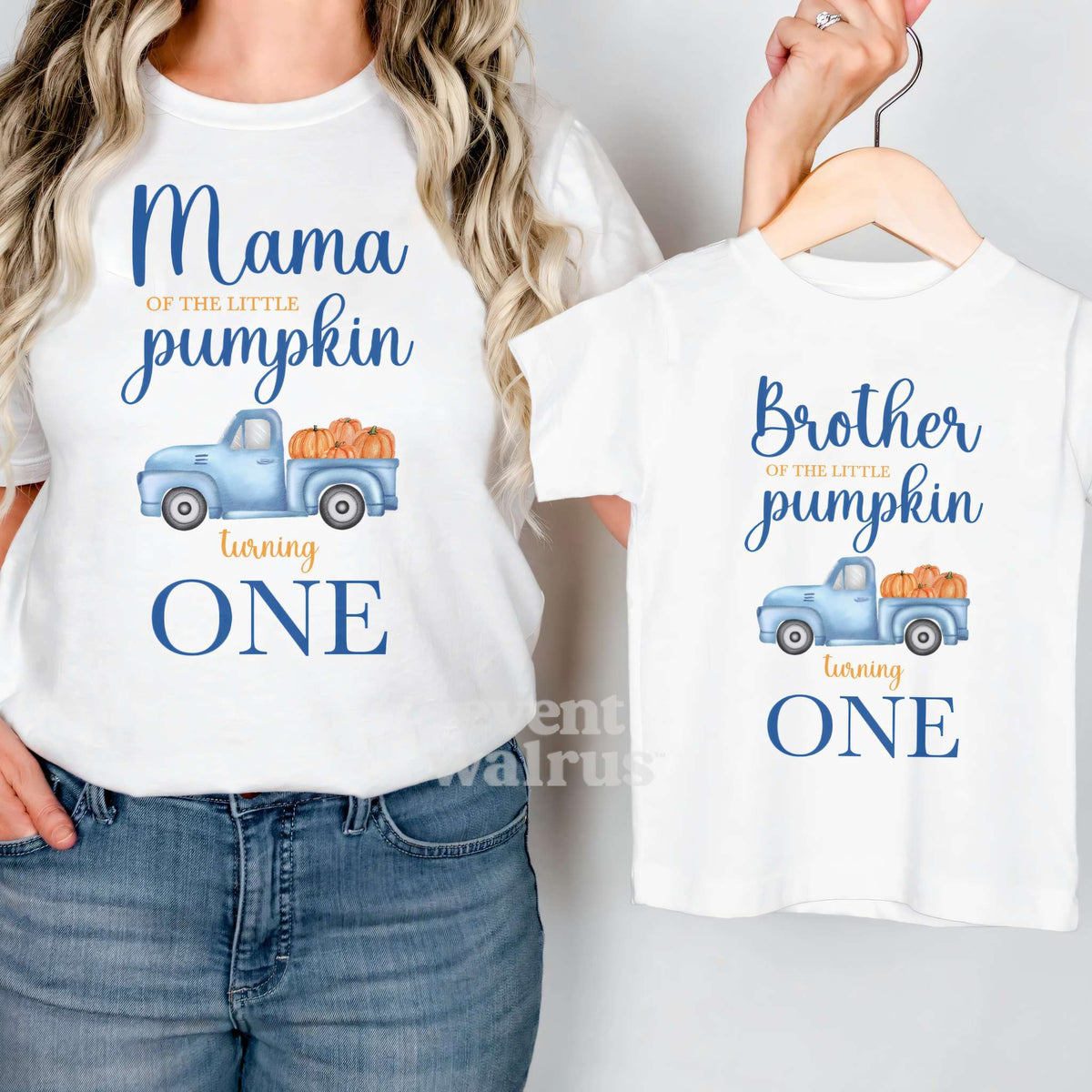 Mom in a white Mama Little Pumpkin shirt holding a matching Brother tee with a blue truck of pumpkins