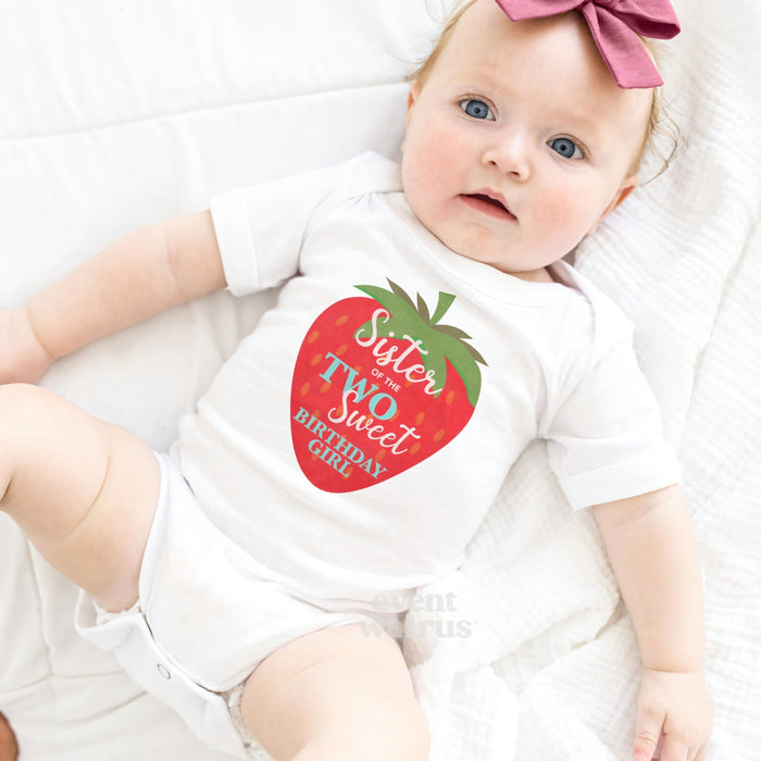 Baby girl with a pink bow lying in a white Sister of the Two Sweet bodysuit.