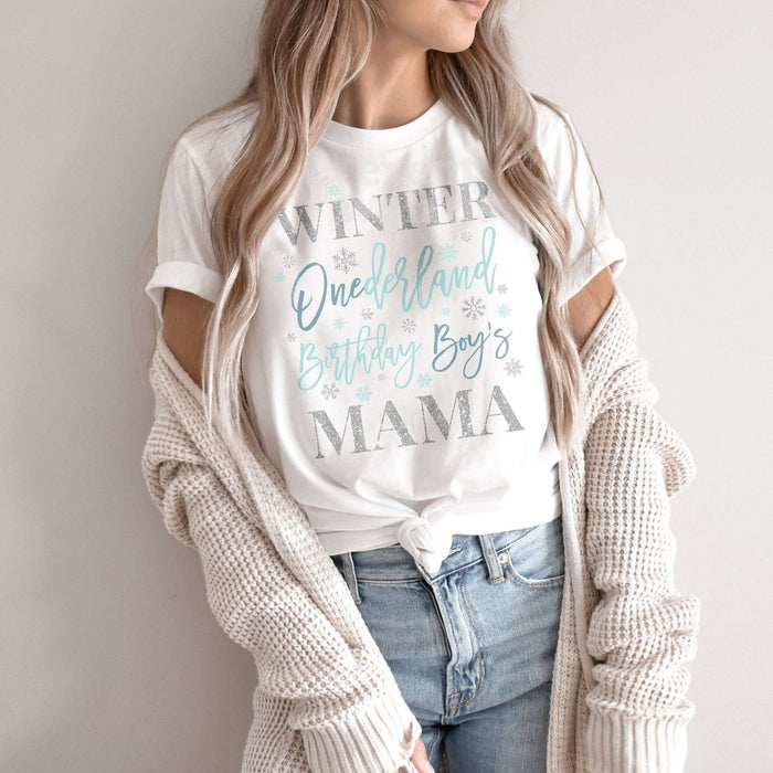 Woman in a knit cardigan wearing a white blue and silver Winter Onederland Mama shirt.