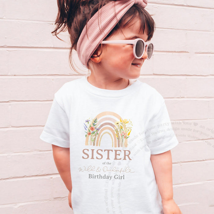 Girl in pink sunglasses wearing a white Sister of the Wild and Onederful Birthday Girl tee.