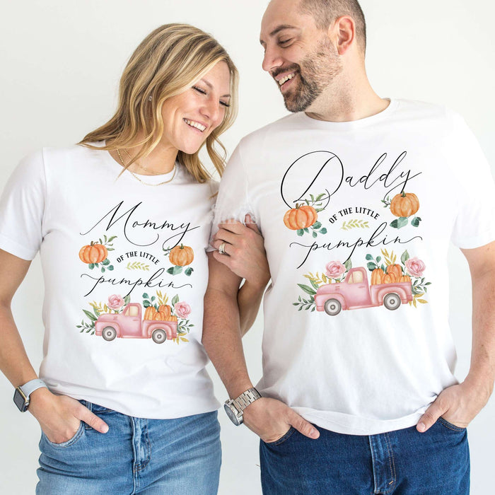 Mom and Dad laughing together in white Mommy and Daddy pink pickup Little Pumpkin shirts.