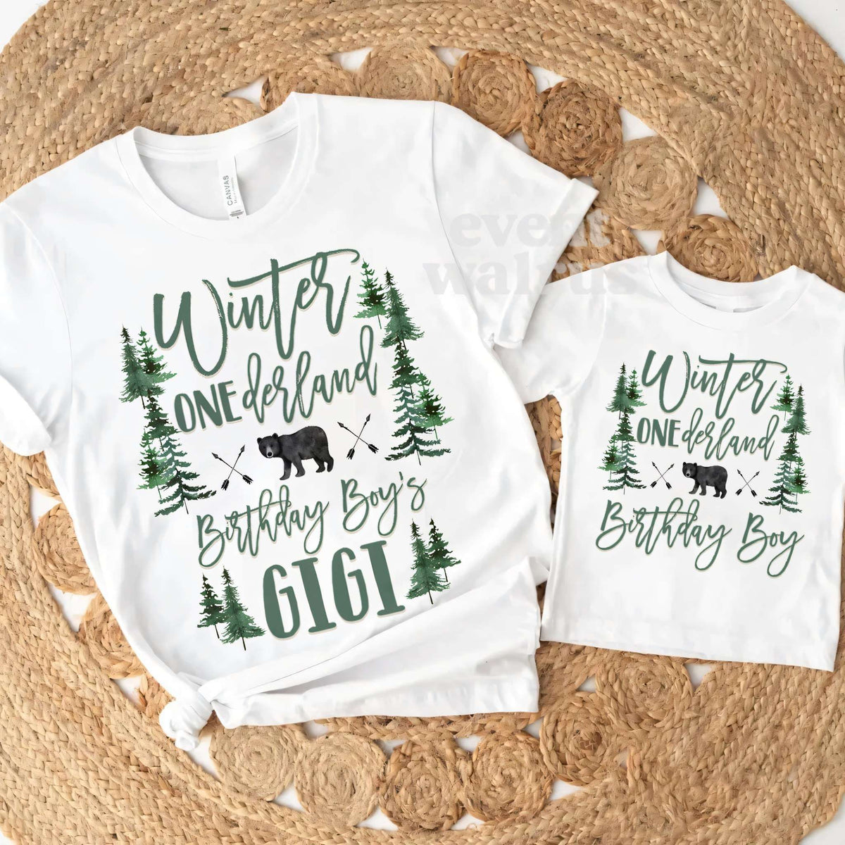 White Gigi tee and the Birthday Boy toddler tee laid on a round jute rug.