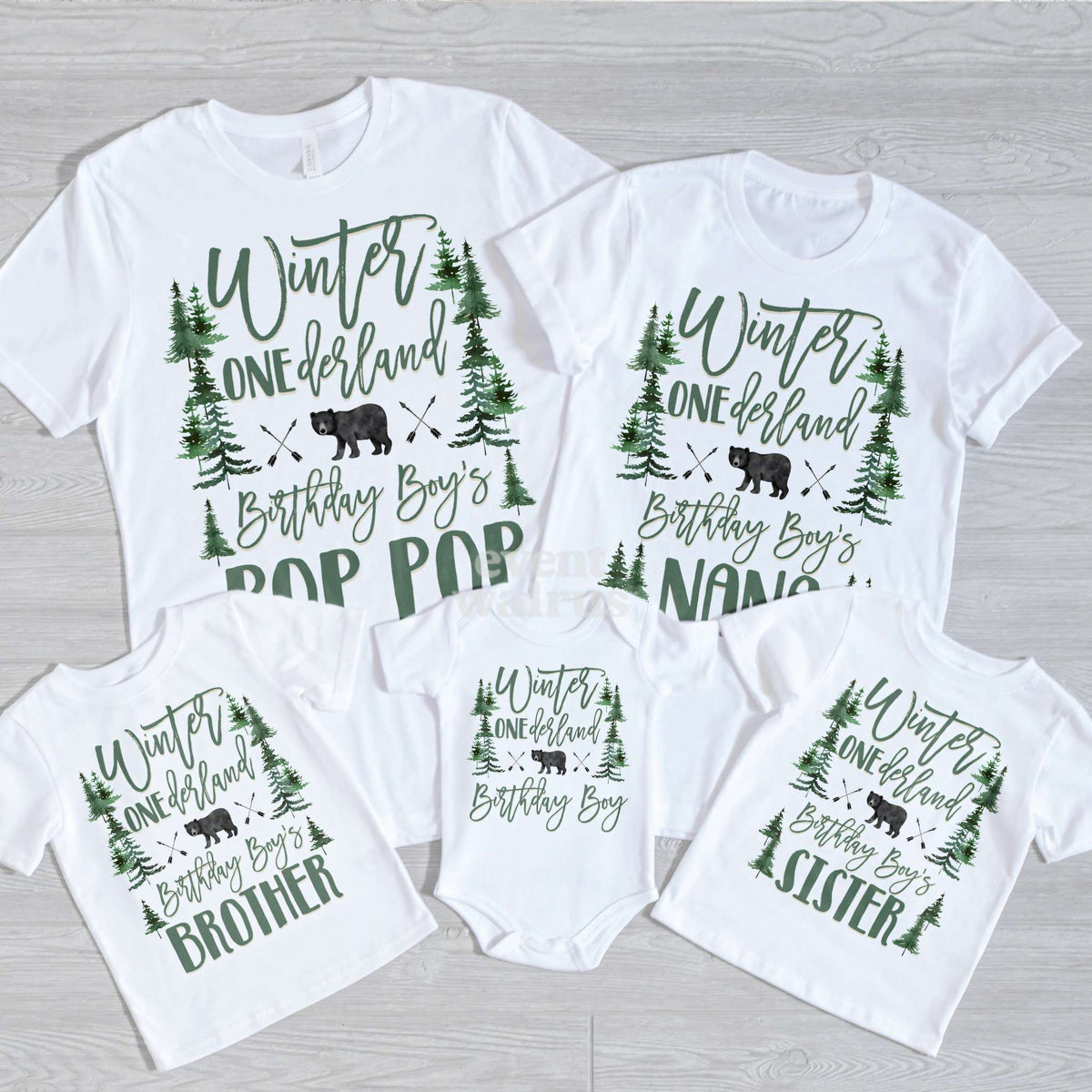 Pop Pop, Nana, Brother, Sister and baby bear forest Winter ONEderland shirts on gray wood.