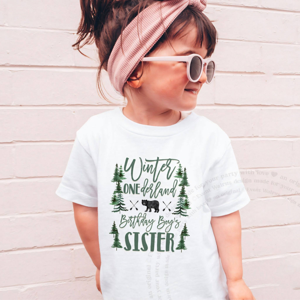 Girl in sunglasses and a pink headband wearing a white Winter ONEderland Birthday Boy's Sister shirt.