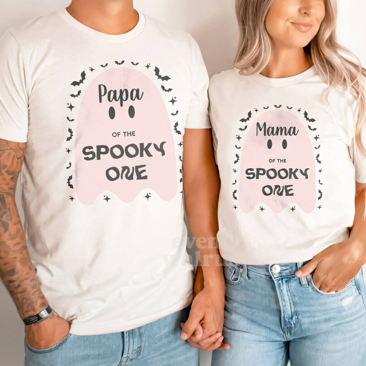 Dad and Mom holding hands in white Papa and Mama big pink ghost Spooky One shirts.