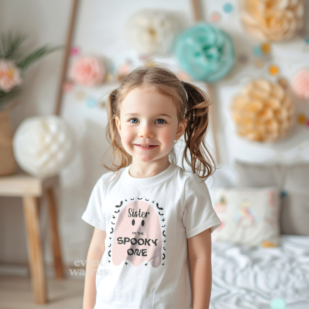 Little girl with pigtails at a pastel party in a white Sister of the Spooky One tee.