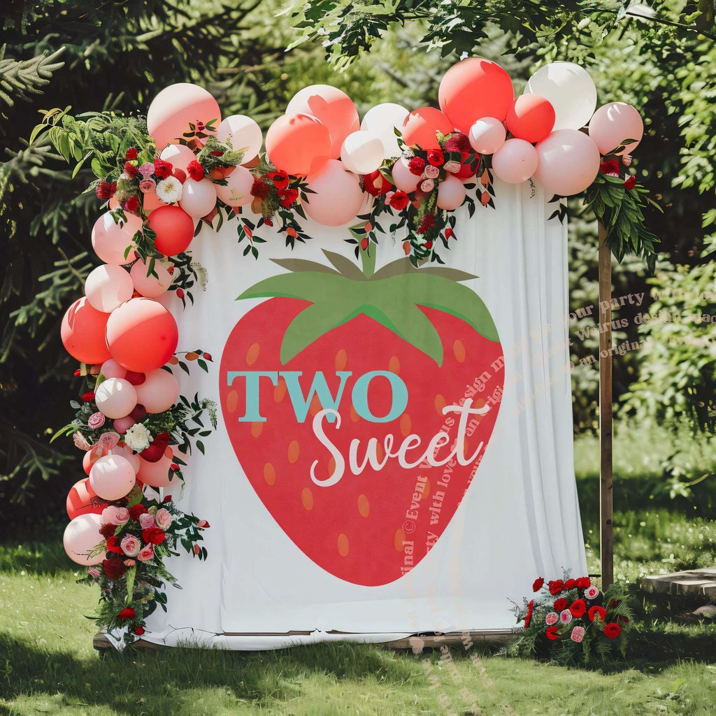 Big strawberry backdrop in a garden with pink and red balloons and roses.