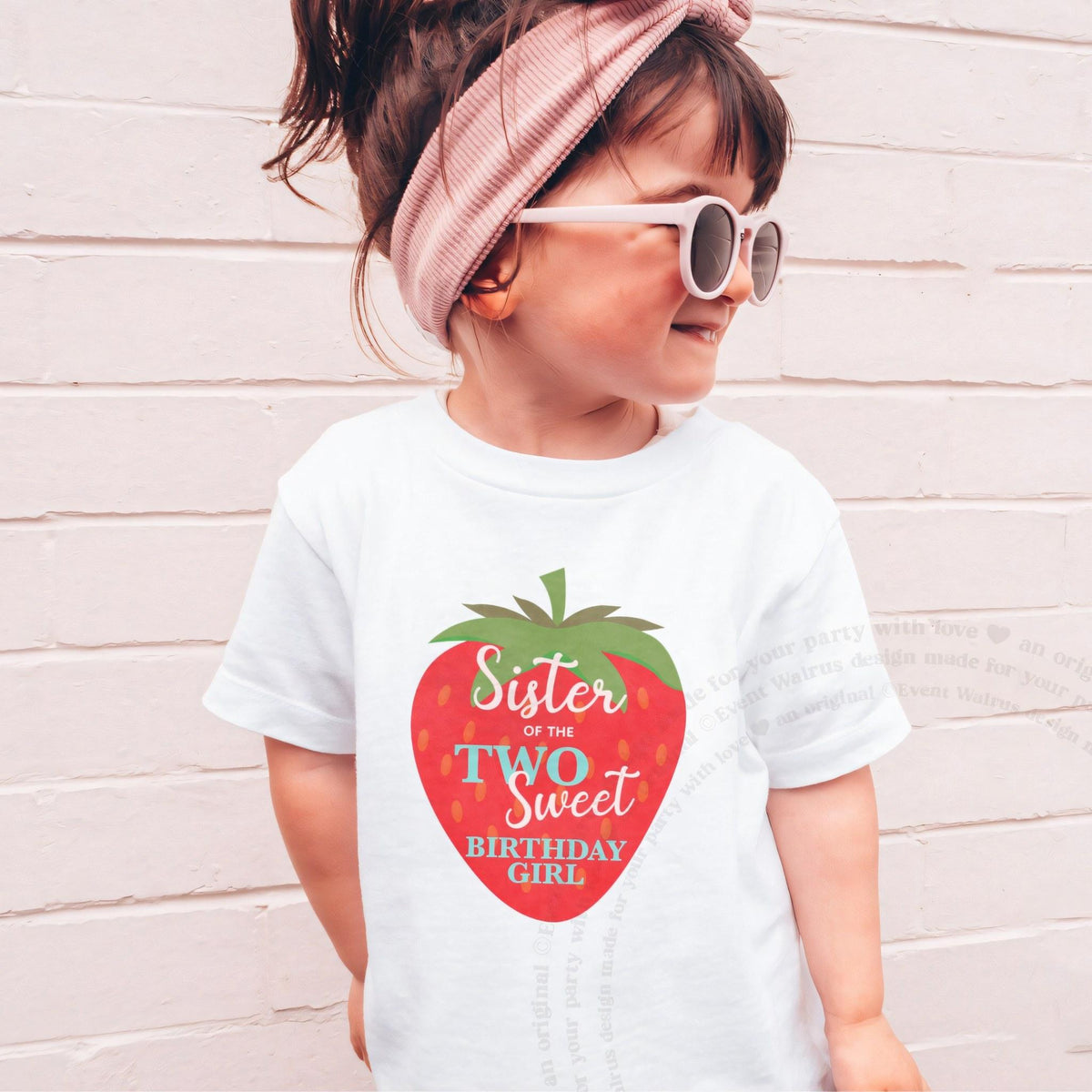 Girl in sunglasses and a pink headband wearing a white Sister of the Two Sweet shirt.