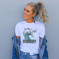 Smiling woman in a white It's the Big One Mommy shirt with a blue watercolor wave.
