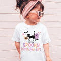 Girl in sunglasses and a pink headband wearing a white I'm the Spooky Birthday Girl shirt.