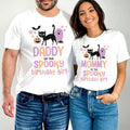 Dad and Mom standing together in white Daddy and Mommy Spooky Birthday Girl shirts.