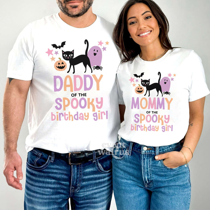 Dad and Mom standing together in white Daddy and Mommy Spooky Birthday Girl shirts.