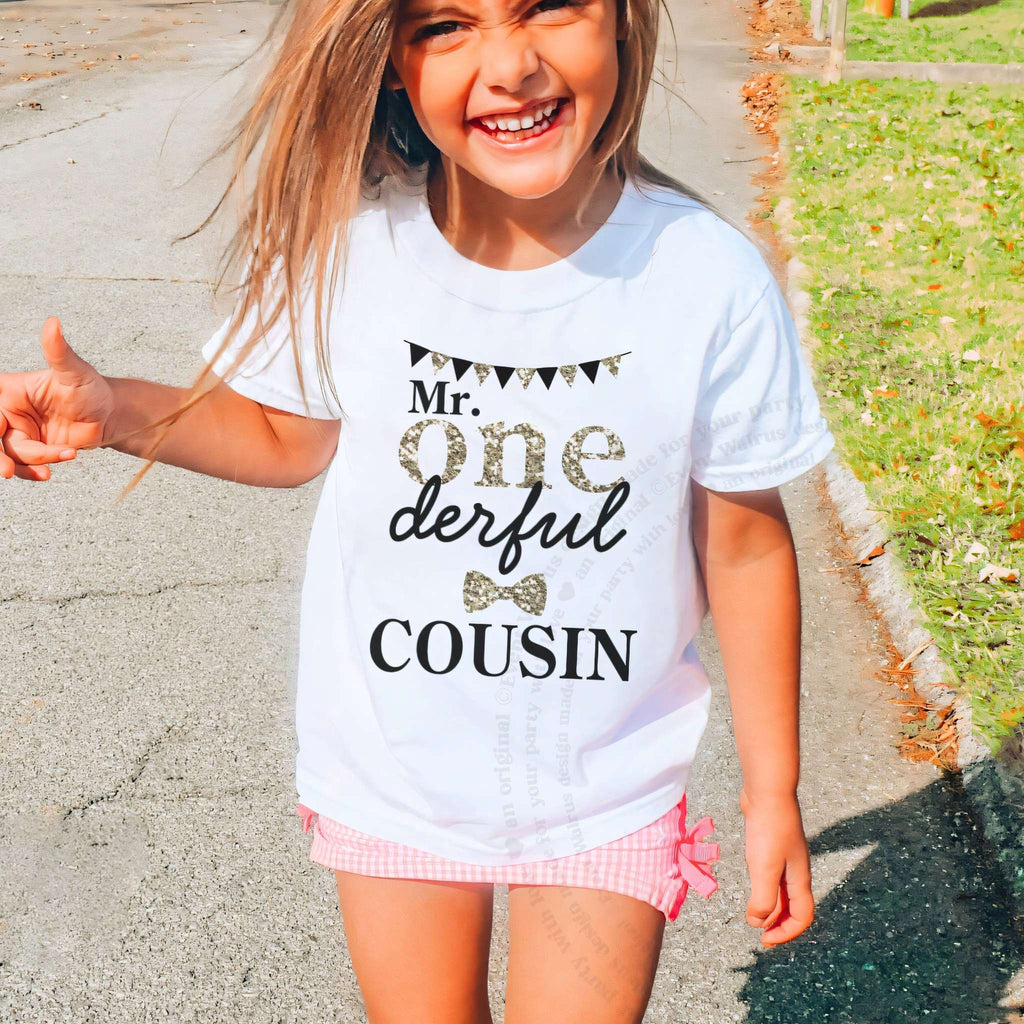 Laughing girl outdoors in a white Mr Onederful Cousin kids tee.