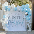 Blue winter onederland first birthday backdrop on a porch with pale blue balloons and a white lantern.