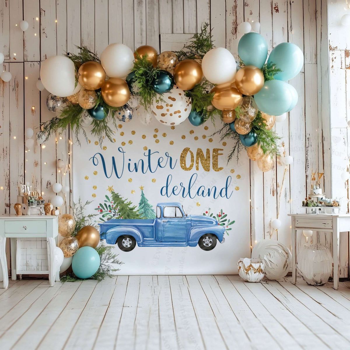 Winter ONE derland truck backdrop in a white wood room under a gold and teal balloon garland.