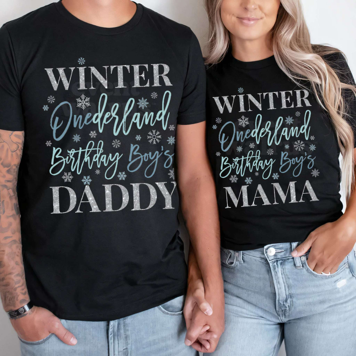 Dad and Mom in black Daddy and Mama Winter Onederland shirts with blue script and silver snowflakes.