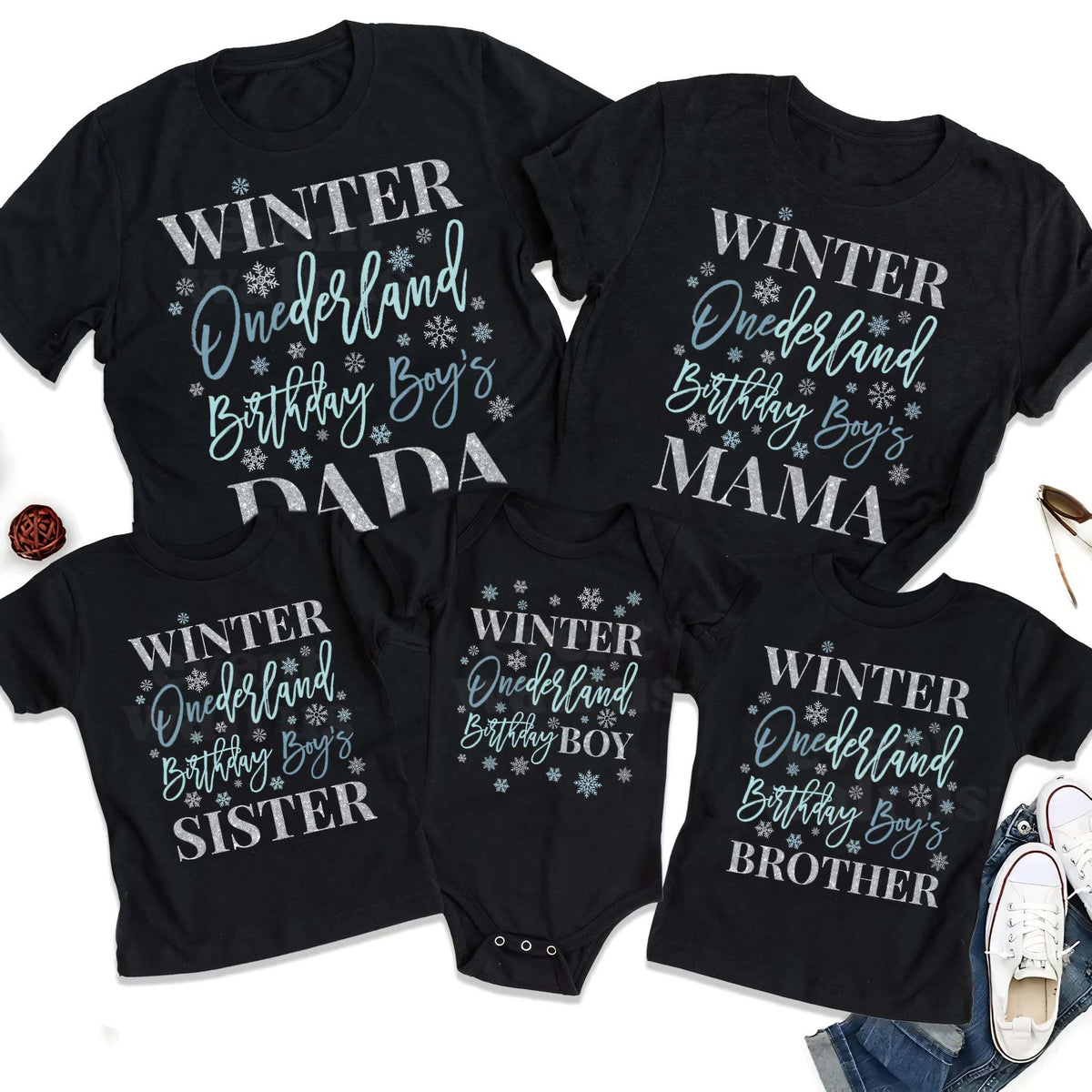 Black Dada, Mama, Sister, Brother and baby Winter Onederland shirts laid out together.