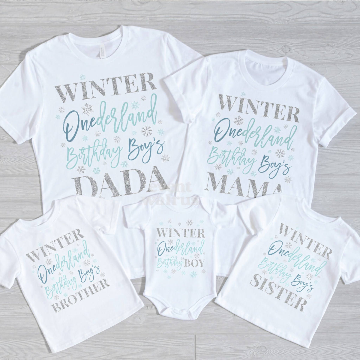 Dada, Mama, Brother, Sister and baby blue and silver Winter Onederland shirts on gray wood.