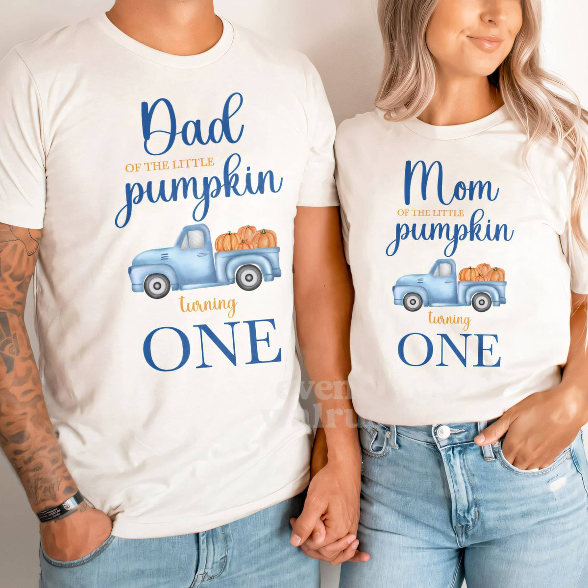 Dad and Mom holding hands in white Dad and Mom Little Pumpkin blue truck shirts.