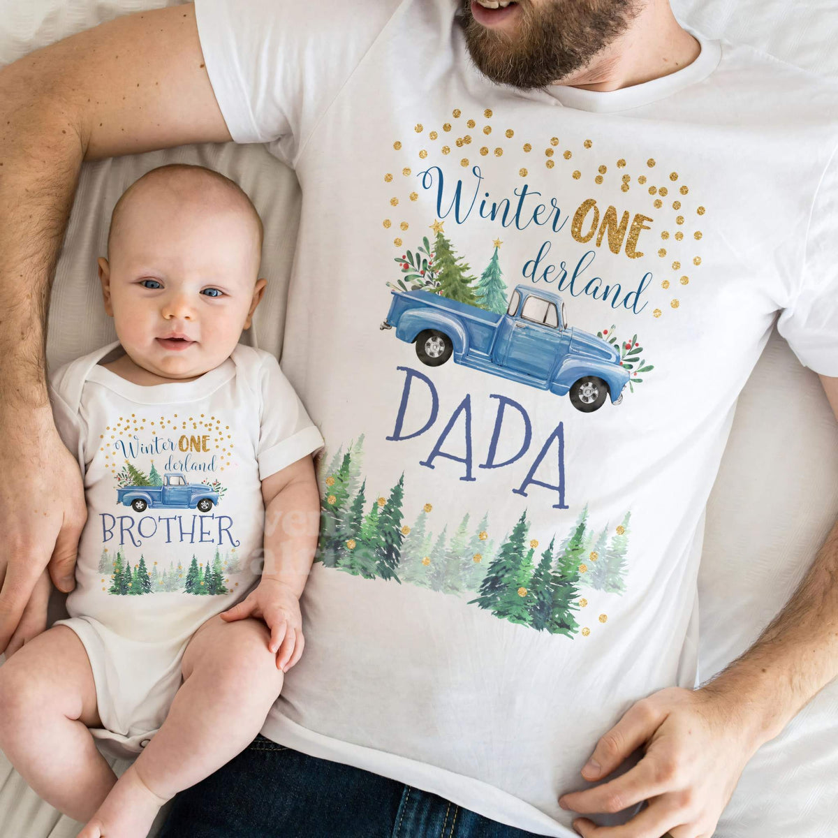 Baby in a blue truck Winter ONE derland Brother bodysuit lying on Dad in his Dada shirt.