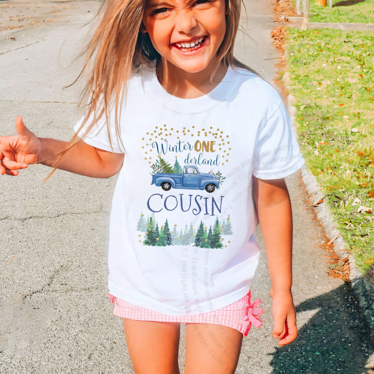Laughing girl outdoors in a white blue truck Winter ONE derland Cousin kids tee.