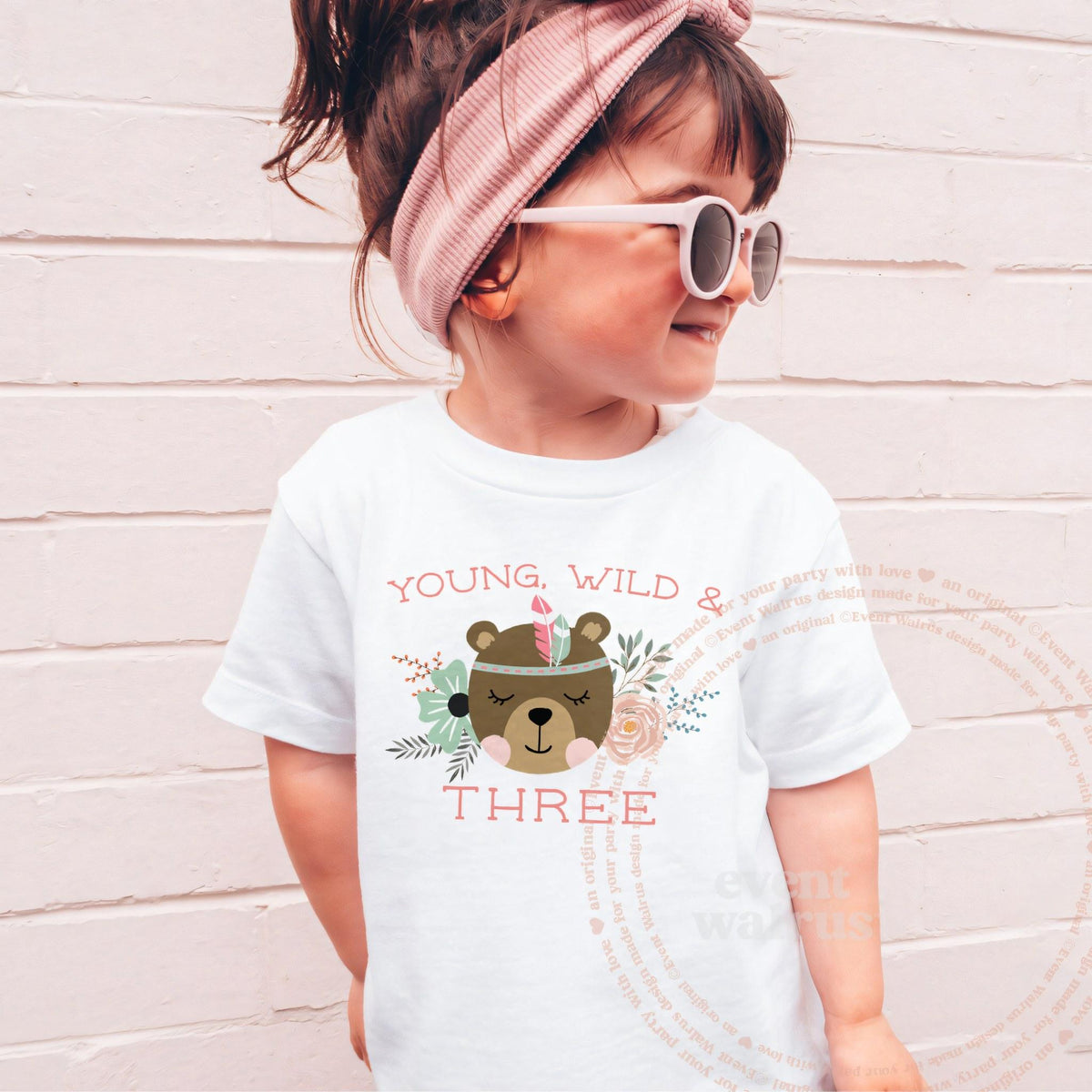 Girl in sunglasses and a pink headband wearing a white Young, Wild and Three birthday shirt.