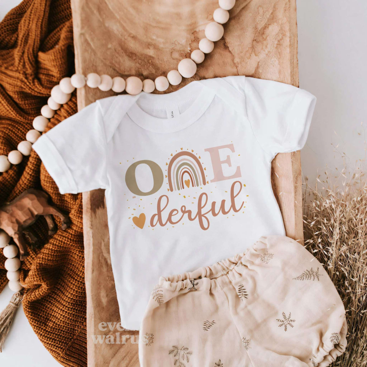 White Onederful baby tee with a boho rainbow, styled with bloomers and wooden beads.