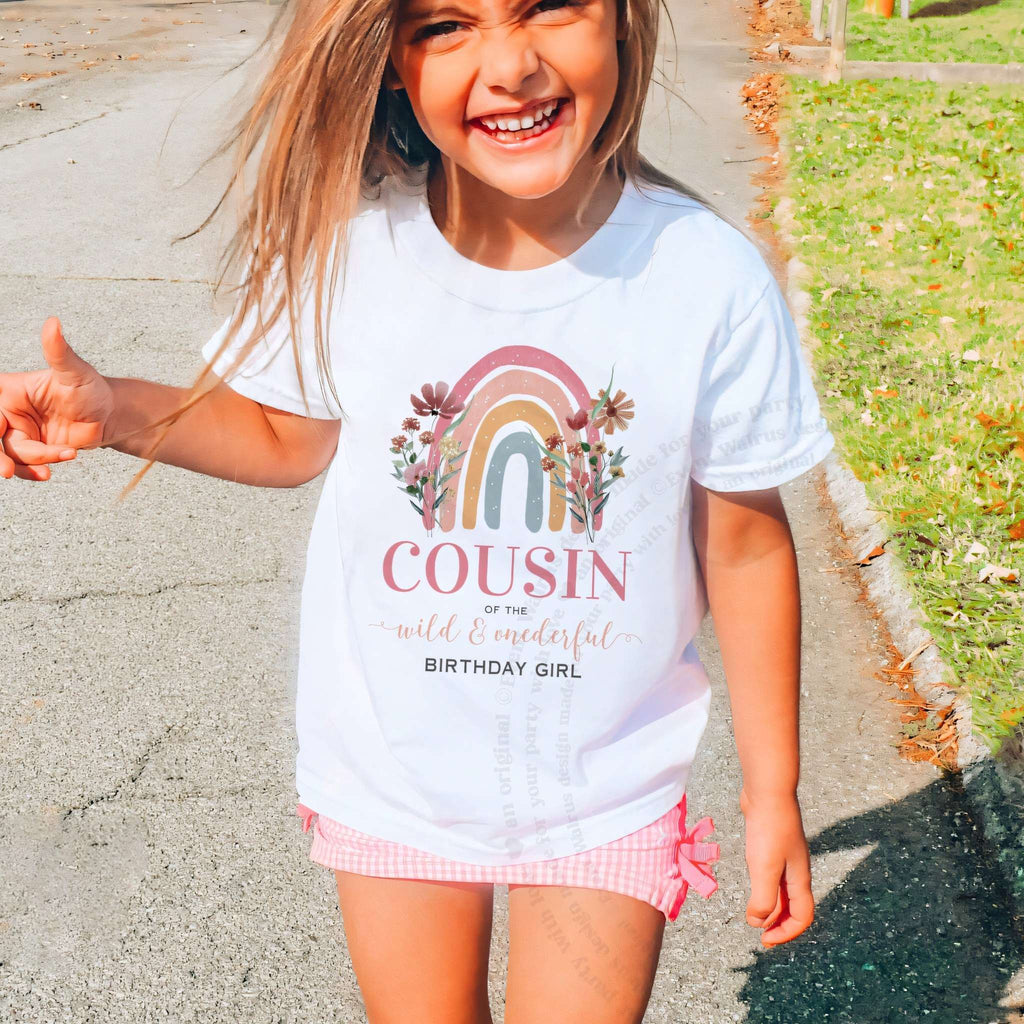 Laughing girl outdoors in a white rainbow Cousin of the Wild and Onederful kids tee.