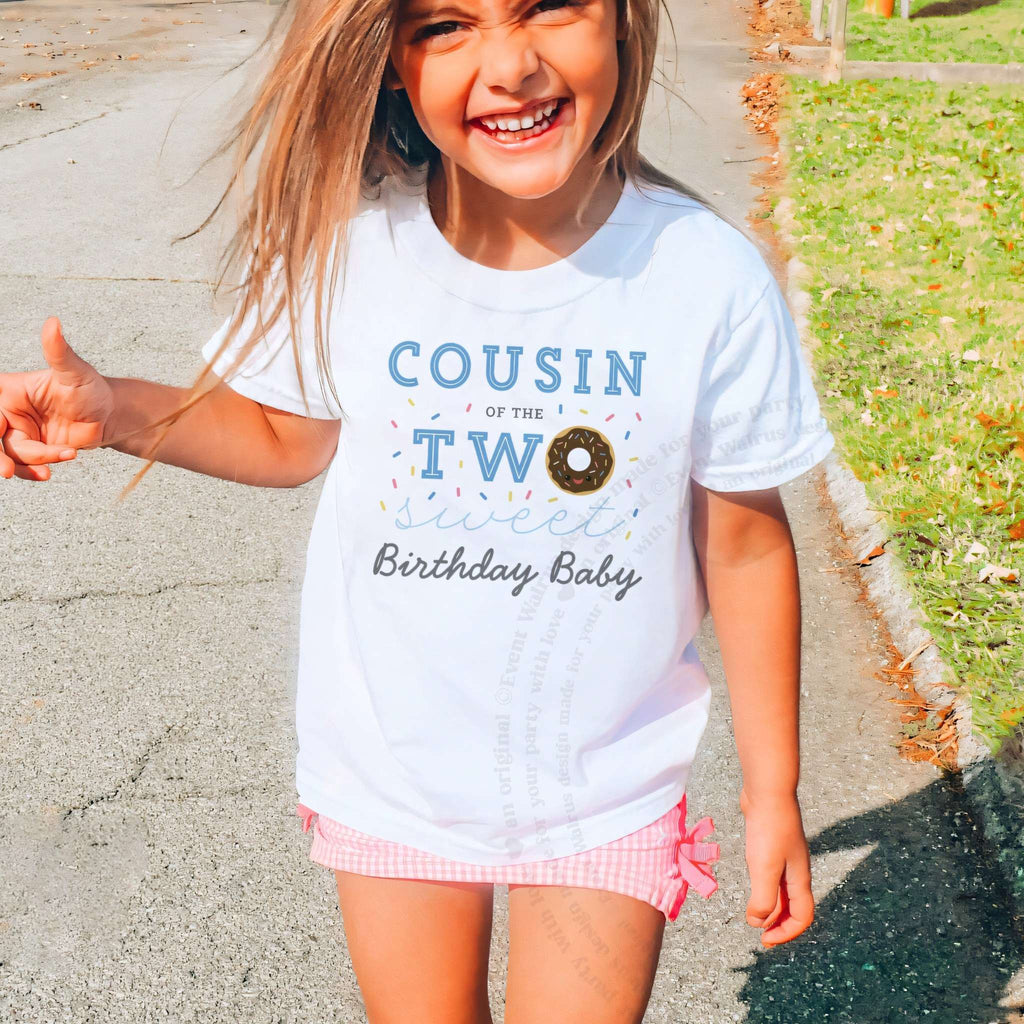 Laughing girl outdoors in a white Cousin of the Two Sweet kids tee.