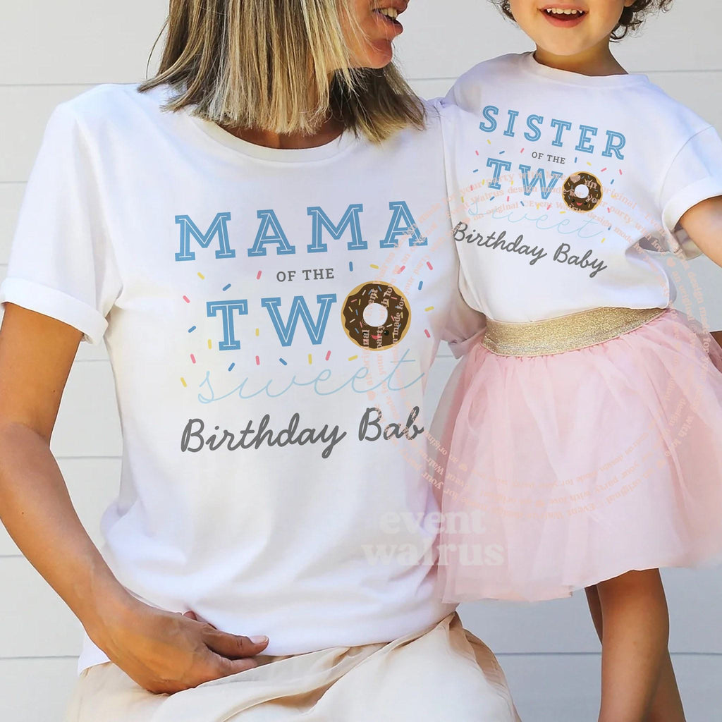 Mom holding hands with her little girl in a tutu, in white Mama and Sister Two Sweet shirts.