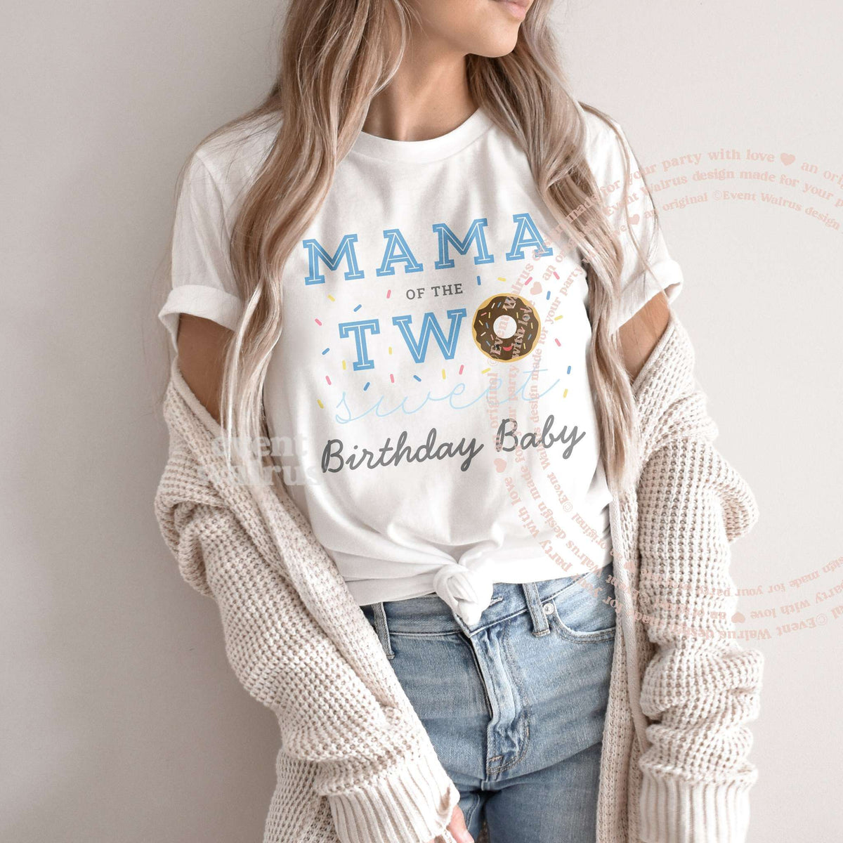 Woman in a knit cardigan wearing a white Mama of the Two Sweet Birthday Baby shirt.