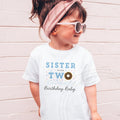 Girl in sunglasses and a pink headband wearing a white Sister of the Two Sweet shirt.