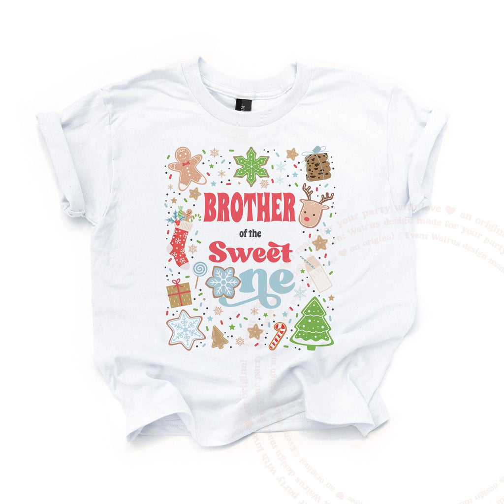 White Brother of the Sweet One kids tee laid flat, covered in Christmas cookies and sprinkles.