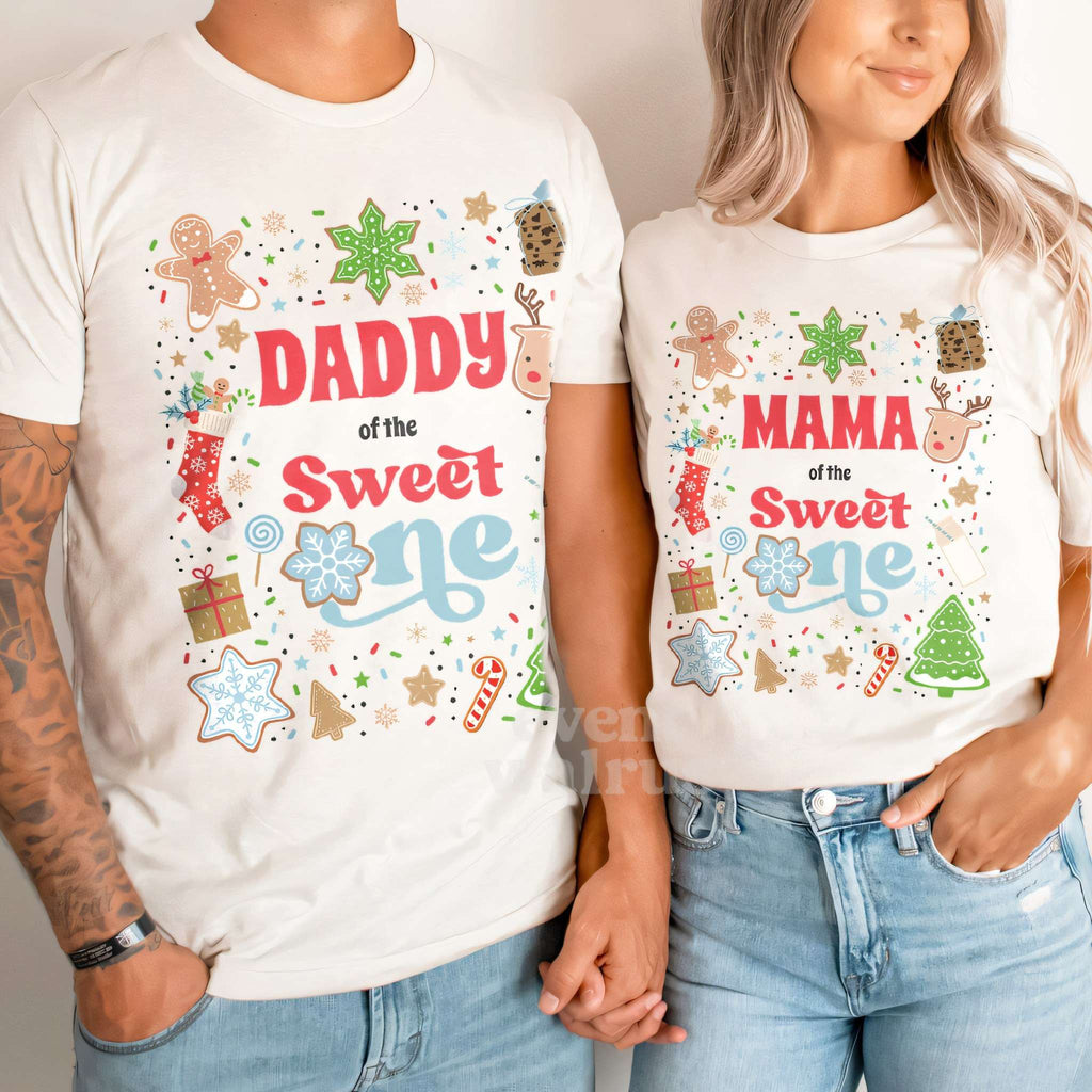 Dad and Mom holding hands in white Daddy and Mama Sweet One Christmas cookie shirts.