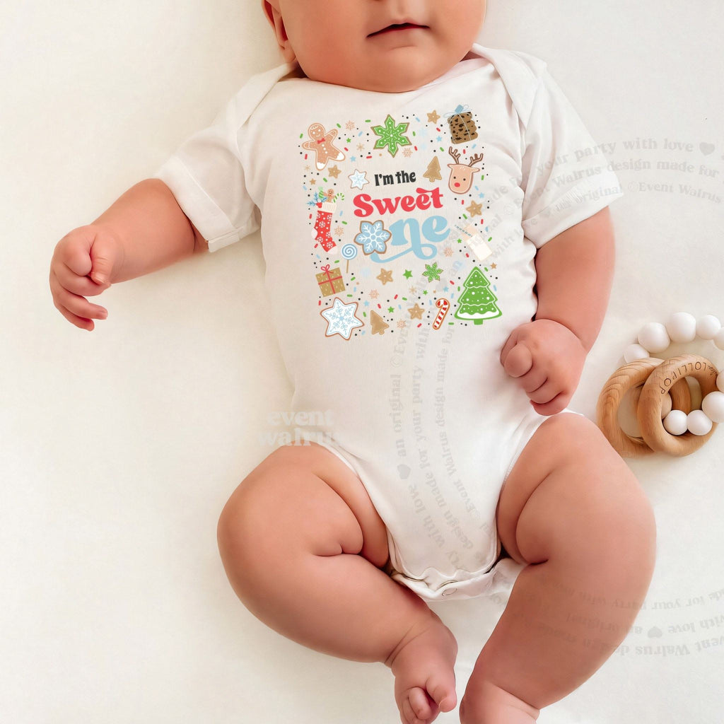 Baby lying on a white blanket in an I'm the Sweet One bodysuit.