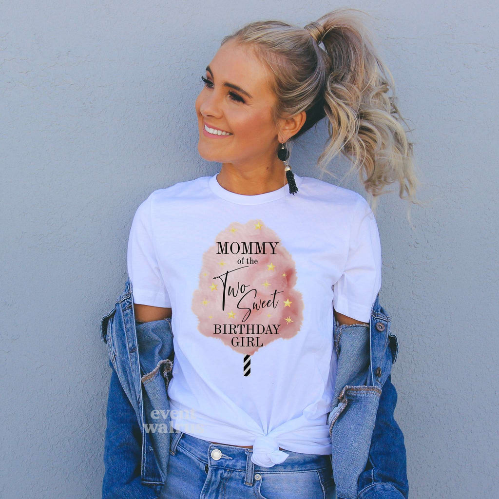 Woman in a denim jacket wearing a Mommy of the Two Sweet Birthday Girl shirt with cotton candy.