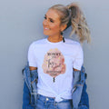 Woman in a denim jacket wearing a Mommy of the Two Sweet Birthday Girl shirt with cotton candy.