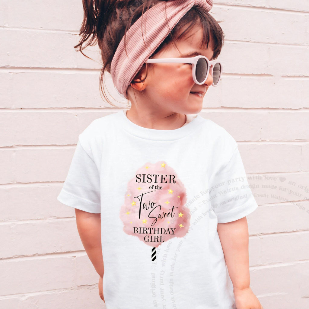 Girl in sunglasses and a pink headband wearing a white Sister of the Two Sweet shirt.