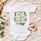 White Four Ever Wild Baby bodysuit laid flat with a wooden teether.