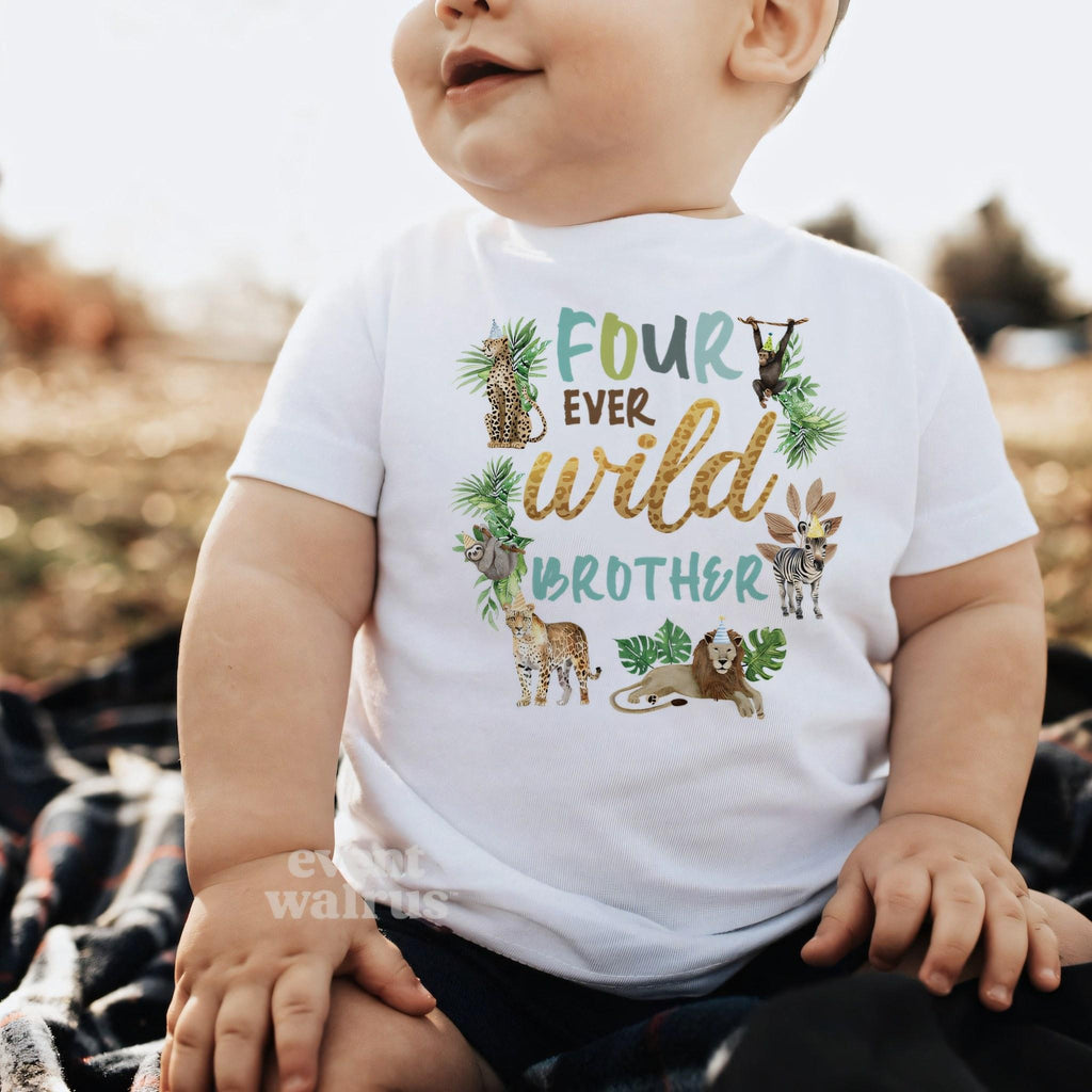 Baby boy sitting outdoors in a white Four Ever Wild Brother baby tee.