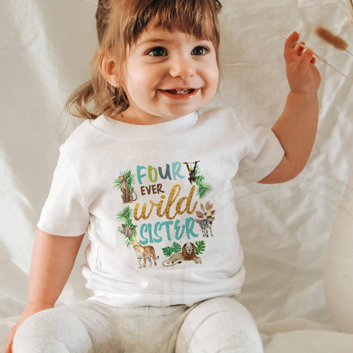 Smiling baby girl in a white Four Ever Wild Sister baby tee.