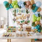 Four ever wild safari backdrop behind a dessert table with teal, green and leopard balloons.