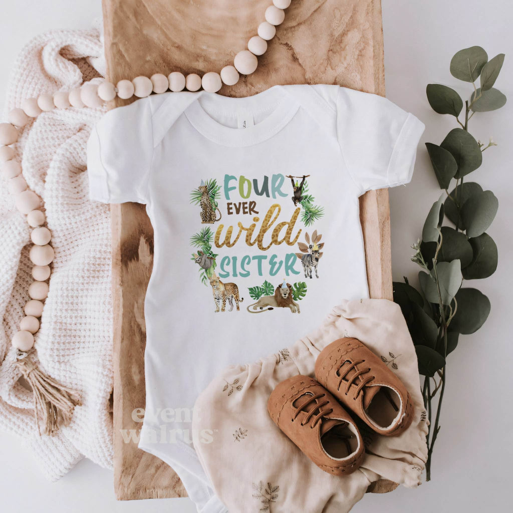 White Four Ever Wild Sister bodysuit laid flat with brown baby shoes and eucalyptus.