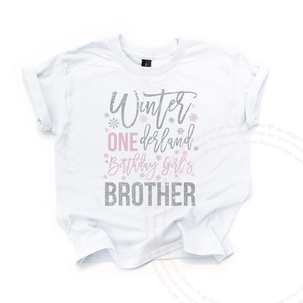 White Winter ONEderland Brother kids tee laid flat, with silver glitter script and a pink ONE.