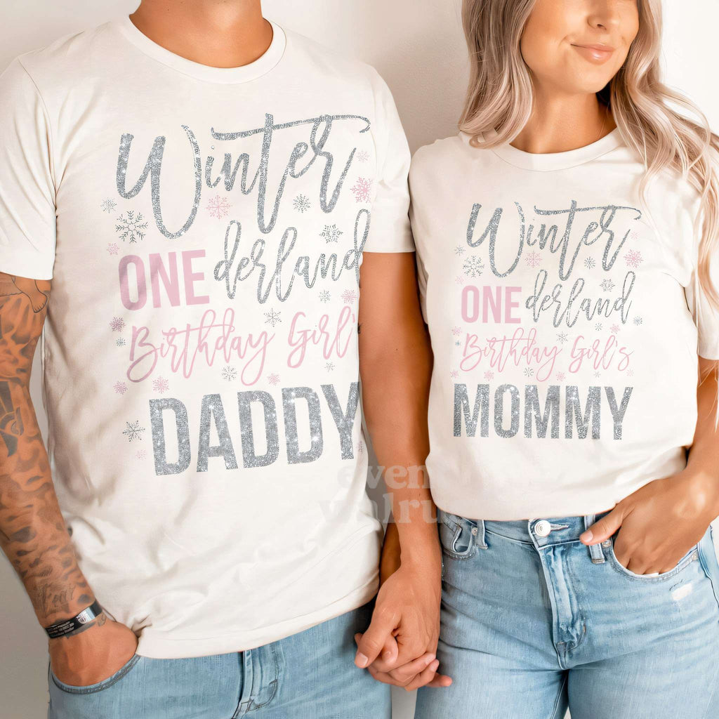 Dad and Mom holding hands in white Daddy and Mommy Winter ONEderland shirts.