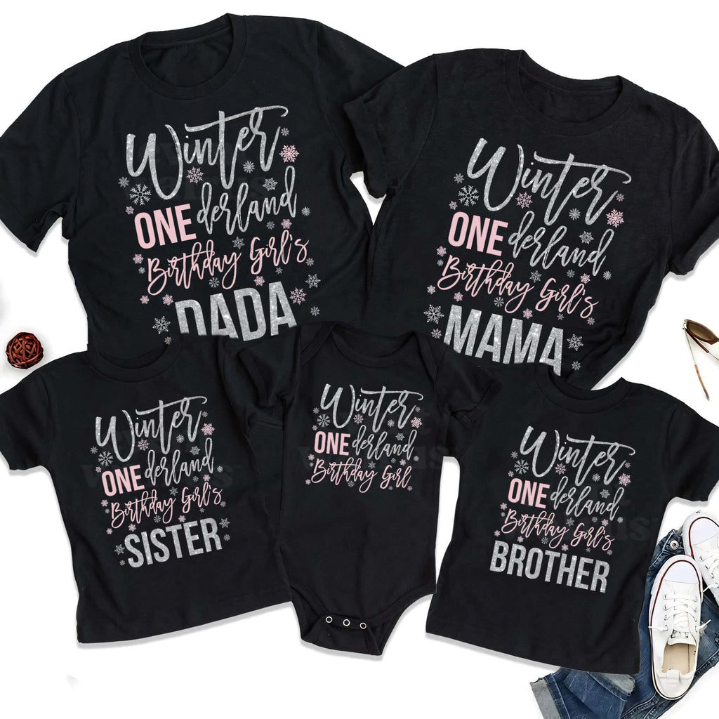 Black Dada, Mama, Sister, Brother and baby Winter ONEderland shirts laid out together.
