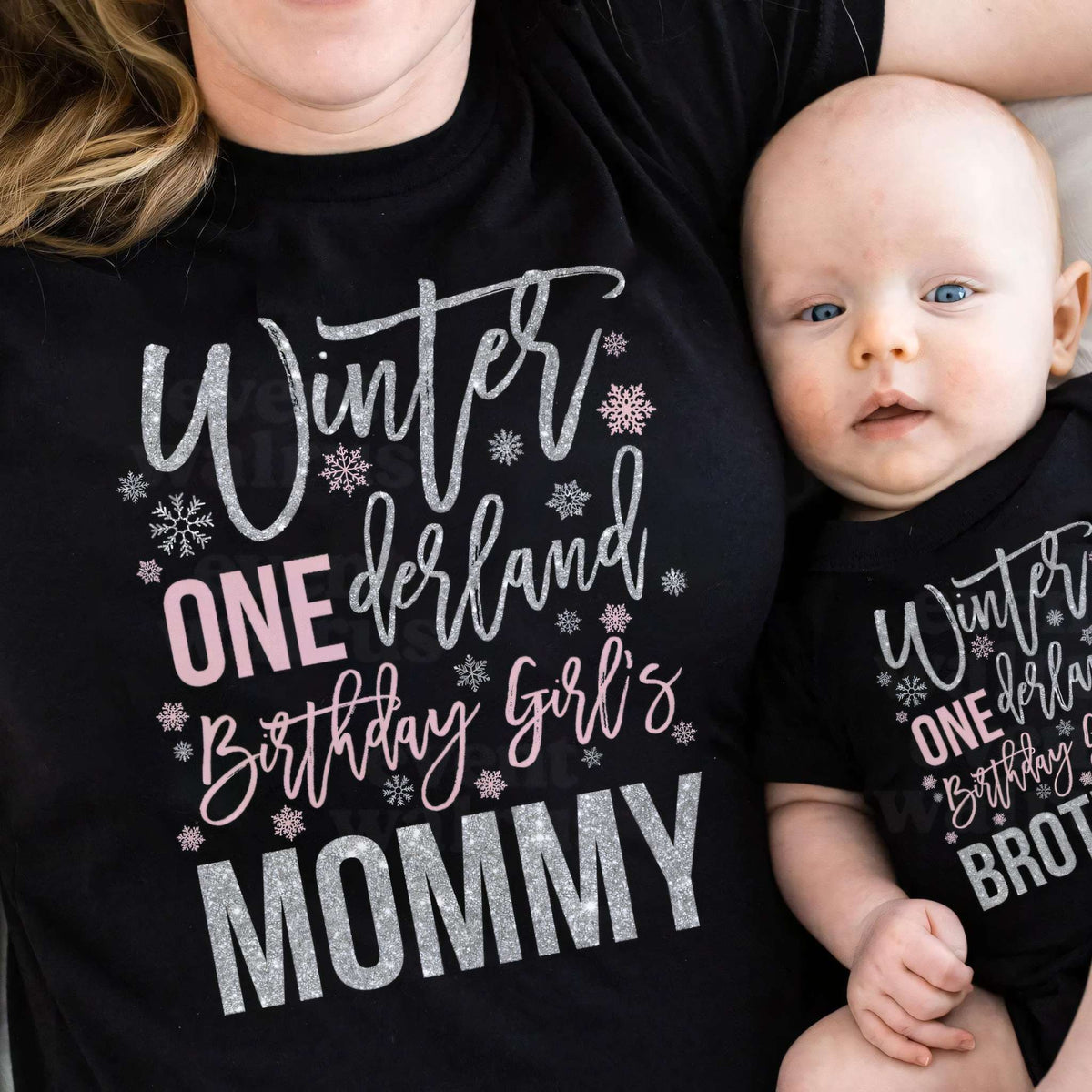 Mom and baby in black Winter ONEderland Mommy and Brother shirts.