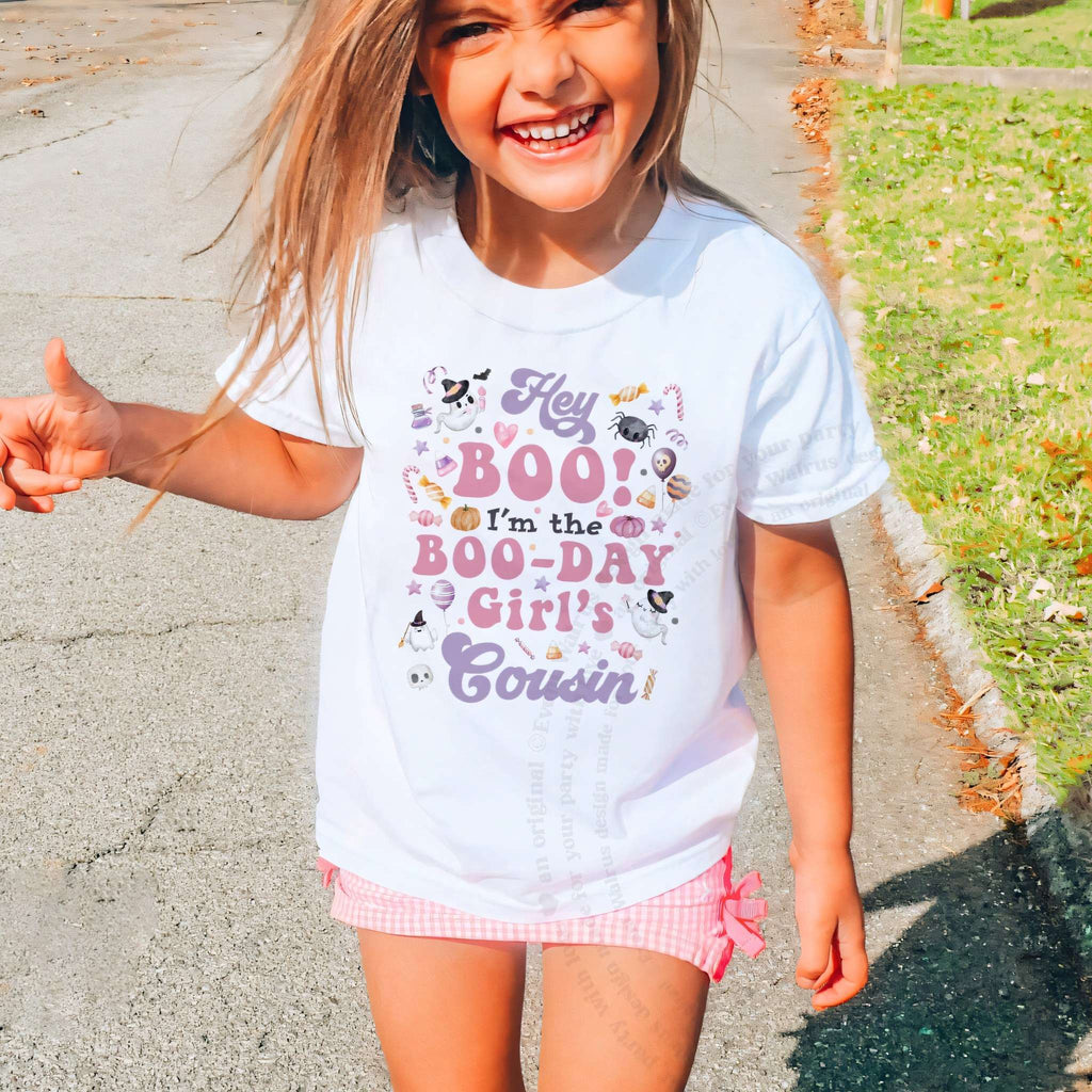Laughing girl outdoors in a white Hey Boo Cousin kids tee.