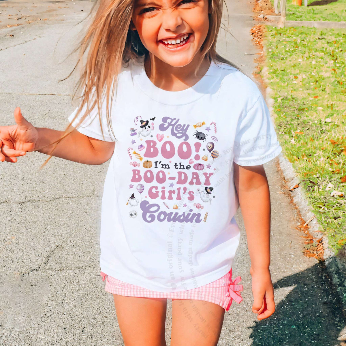 Laughing girl outdoors in a white Hey Boo Cousin kids tee.