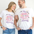 Mom and Dad laughing together in white Hey Boo Boo-Day Girl's Mommy and Daddy shirts.